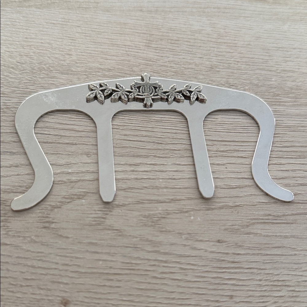 silver tone metal music book clip or page holder.